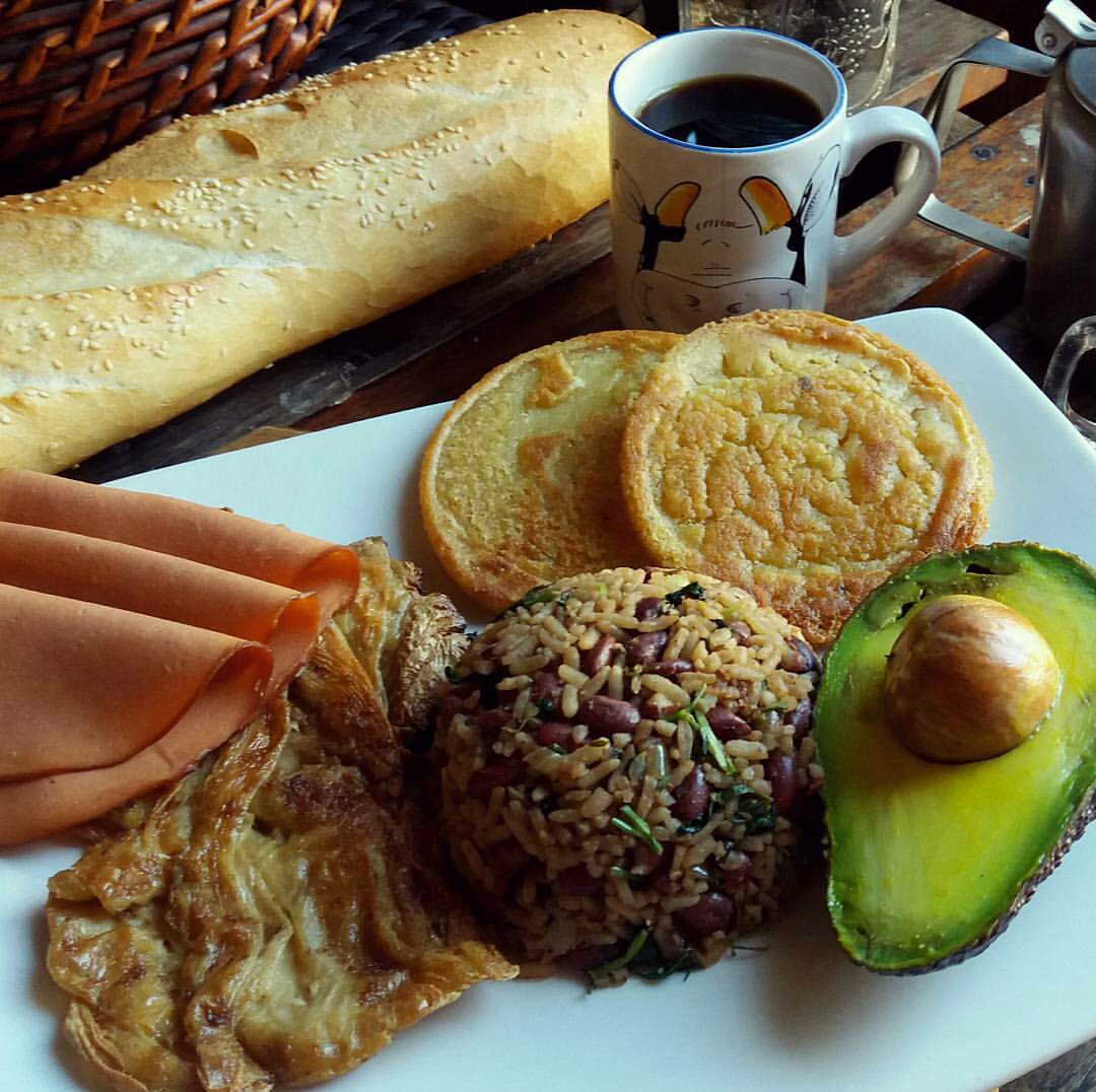 Breakfast plate with gallo pinto, avocado, and Costa Rican coffee